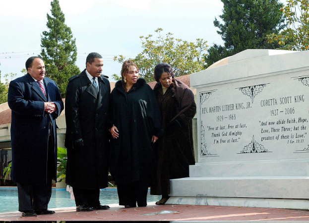 The King family paying homage to Martin Luther King Jr. and Coretta Scott King next to their tombs. 