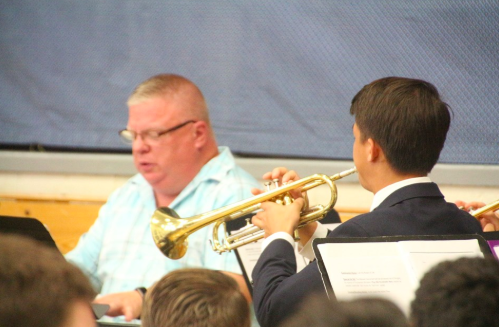 Music teacher Mr. Van Hoven plays the piano while senior Steven Fudenna plays the trumpet as part of the Music Ministry.
