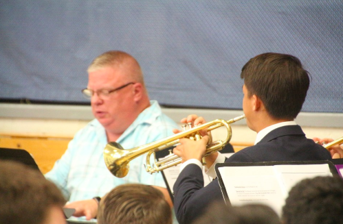 Music teacher Mr. Van Hoven plays the piano while senior Steven Fudenna plays the trumpet as part of the Music Ministry.
