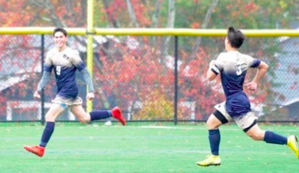 Junior Douglas Colandrea (#9) runs towards the bleachers to celebrate his game-winning goal to defeat Pope John 1-0 on Tuesday, October 30. Senior captain Steven Fudenna (#3) sprints to join him.