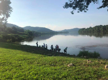 The group skipping rocks on the Ohio river, taking in the natural beauty of the surrounding landscape and appreciating God’s Creation.