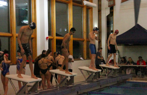 Junior Patrick Tarka (Left) and senior Kyle Roethlin (Second Right) prepare to begin the 100 Free